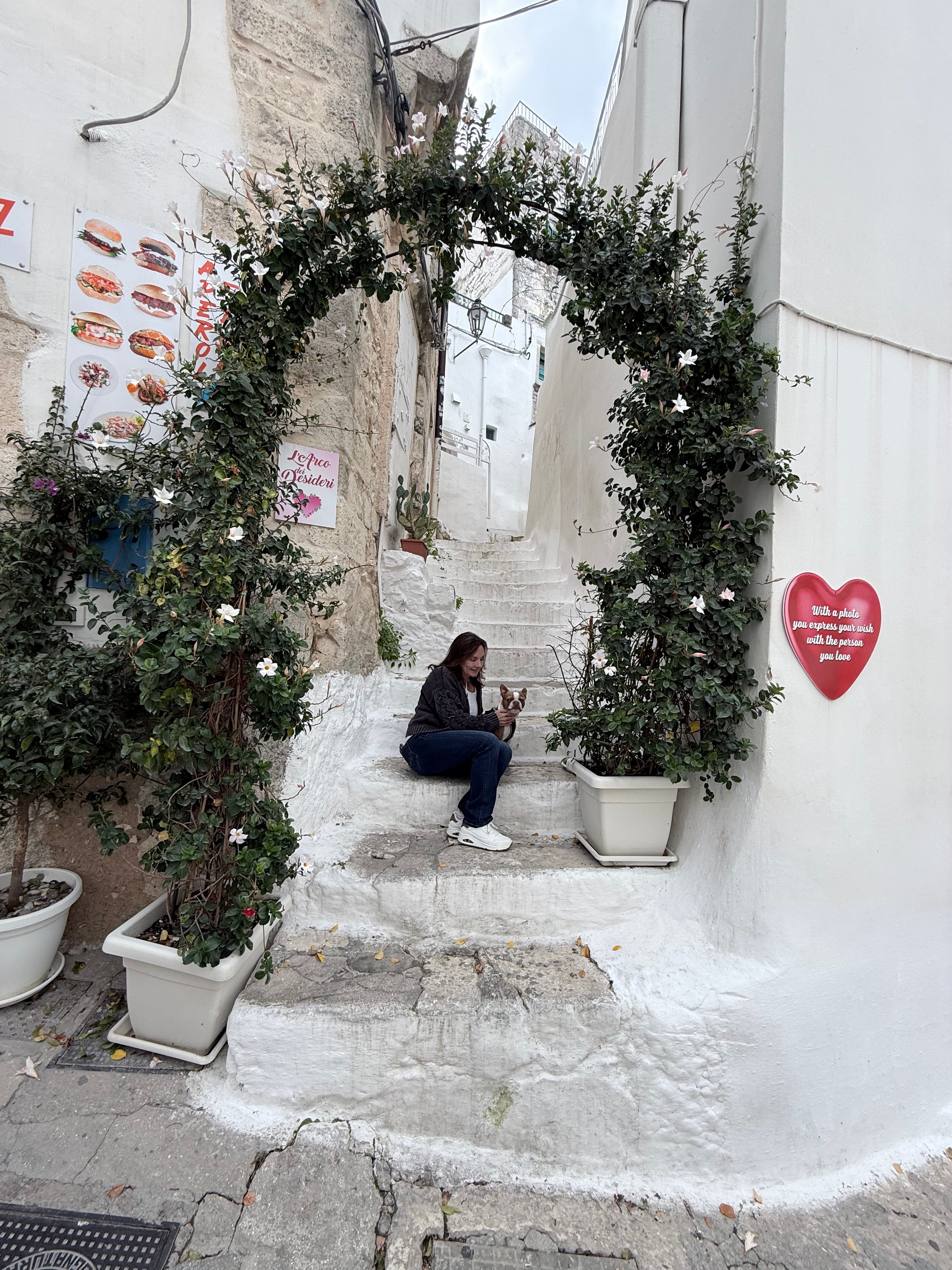 Flower-draped café alley in Italy